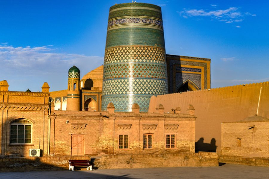 Kalta Minor Minaret and the historic architecture of Itchan Kala, walled inner town of the city of Khiva, Uzbekistan a UNESCO World Heritage Site.