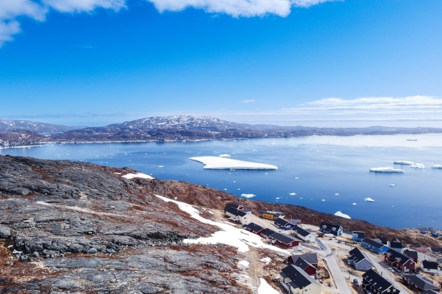 Aerial view small beautiful village over snow in Greenland Europe by drone